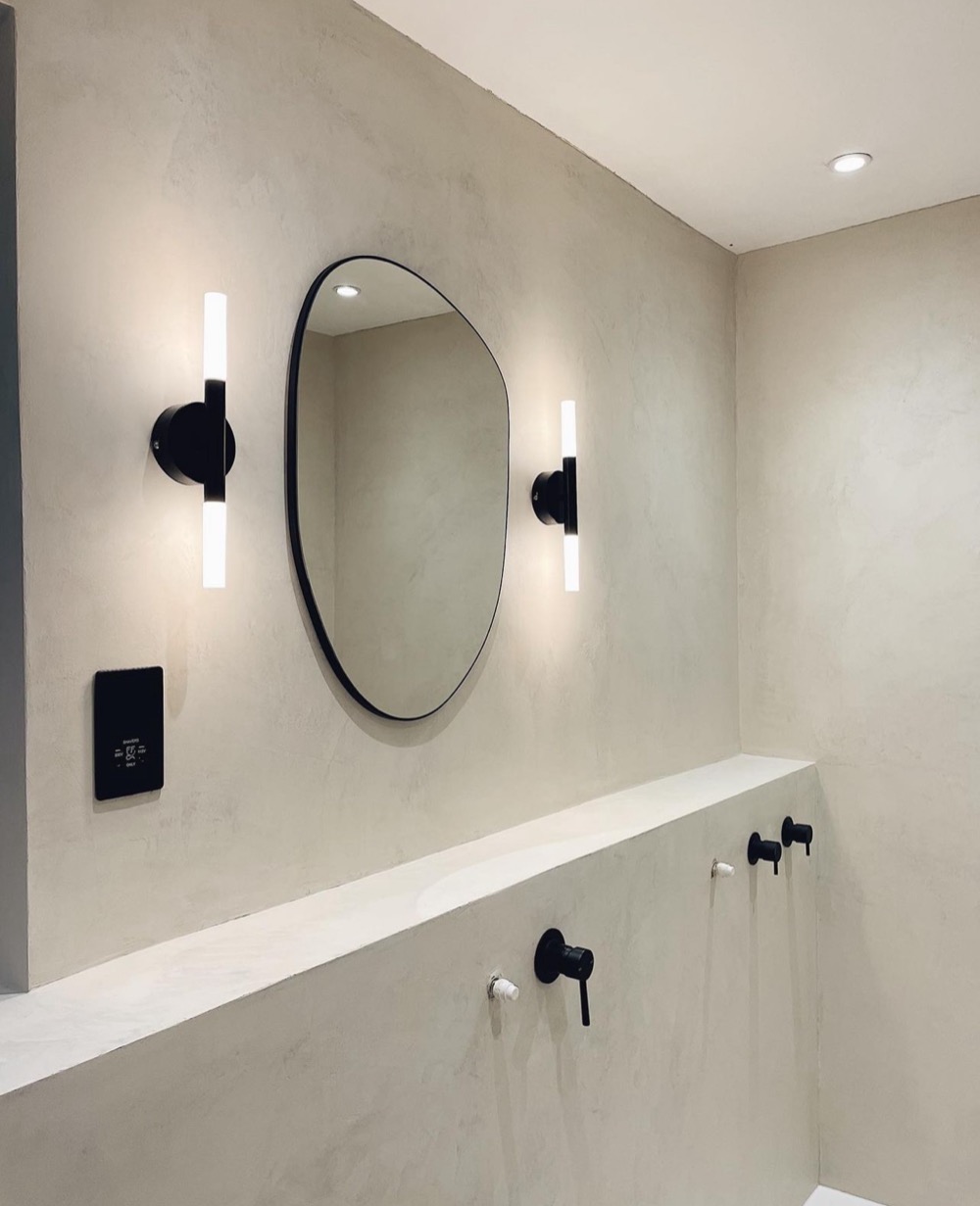 Microcement bathroom wall with designer mirror Toronto